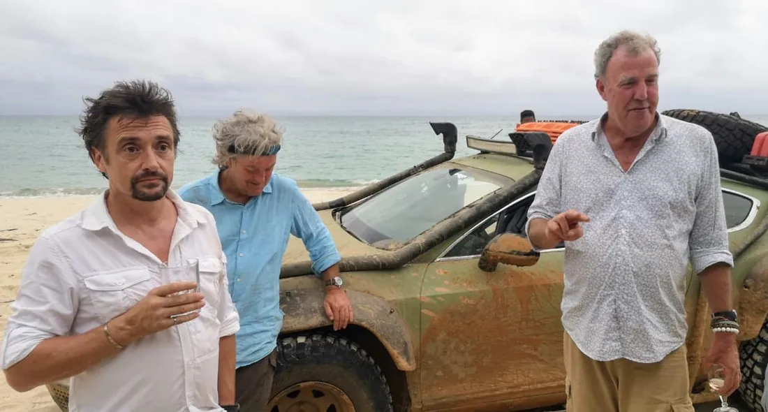 The Grand Tour presenters on a beach in Madagascar beside their off-road car