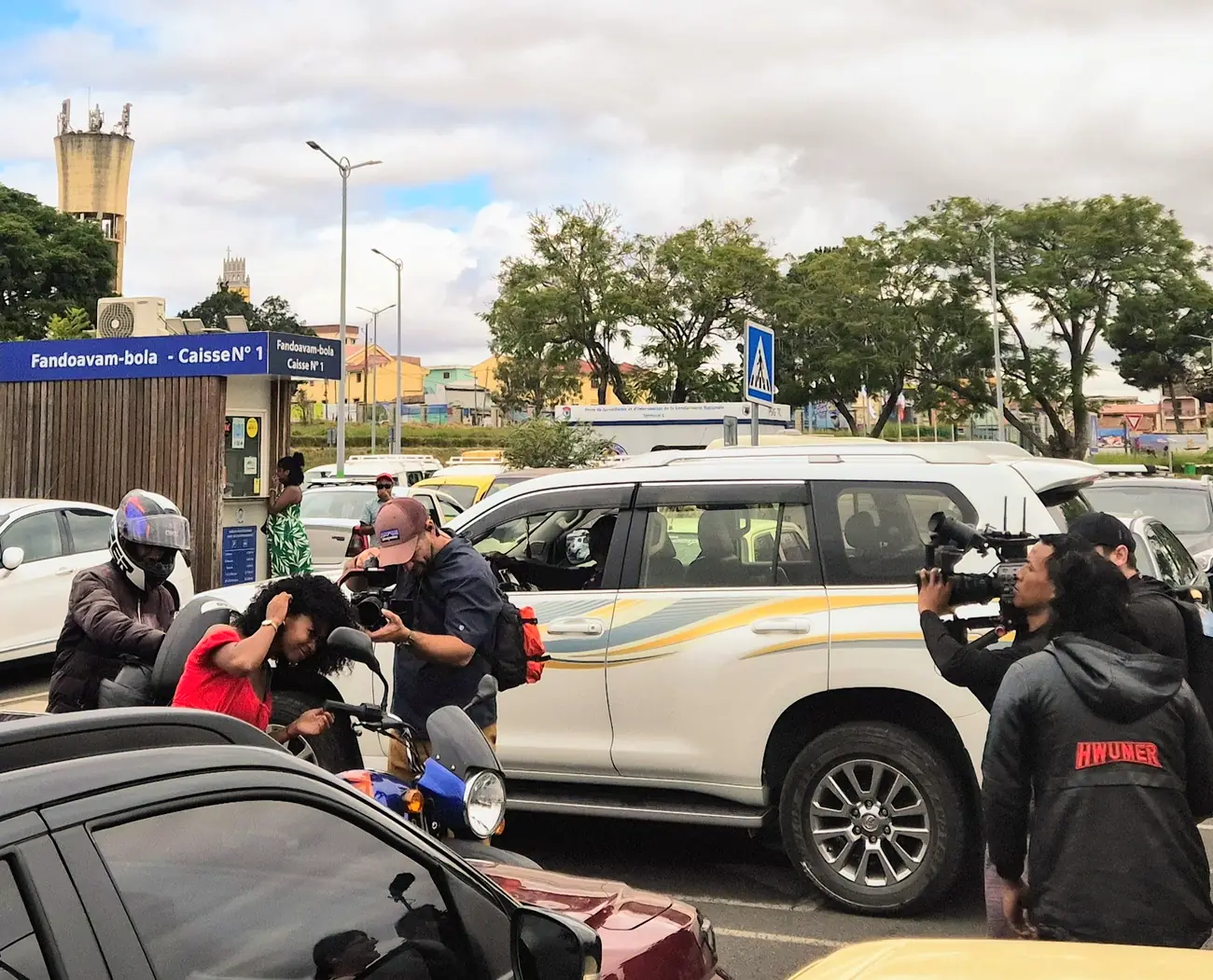 Two camera operators filming a scene in a car park in Madagascar